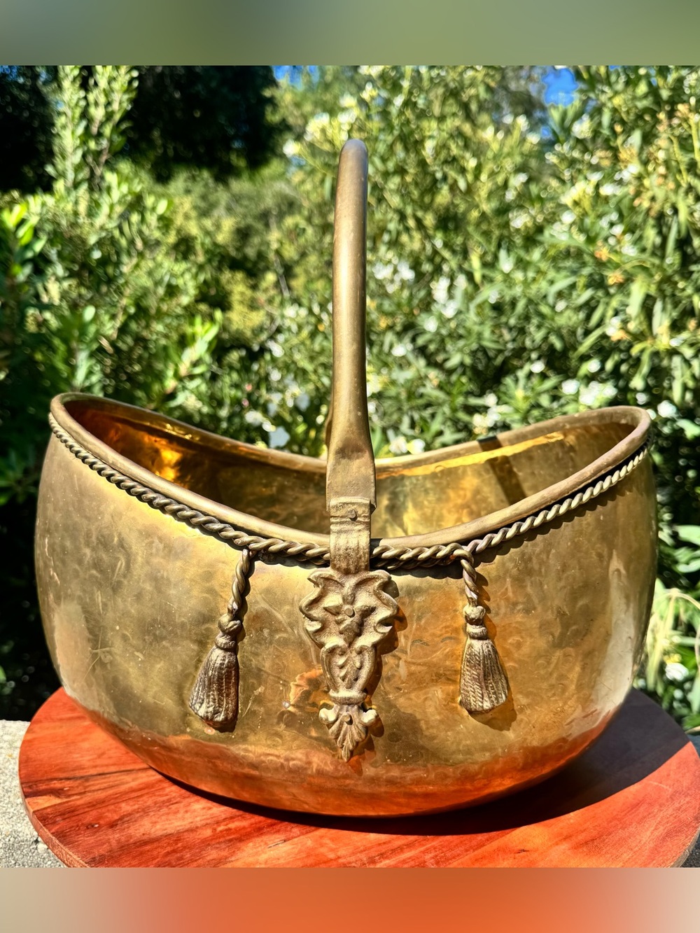 Large sold brass decorative basket with tassel accents and movable handle